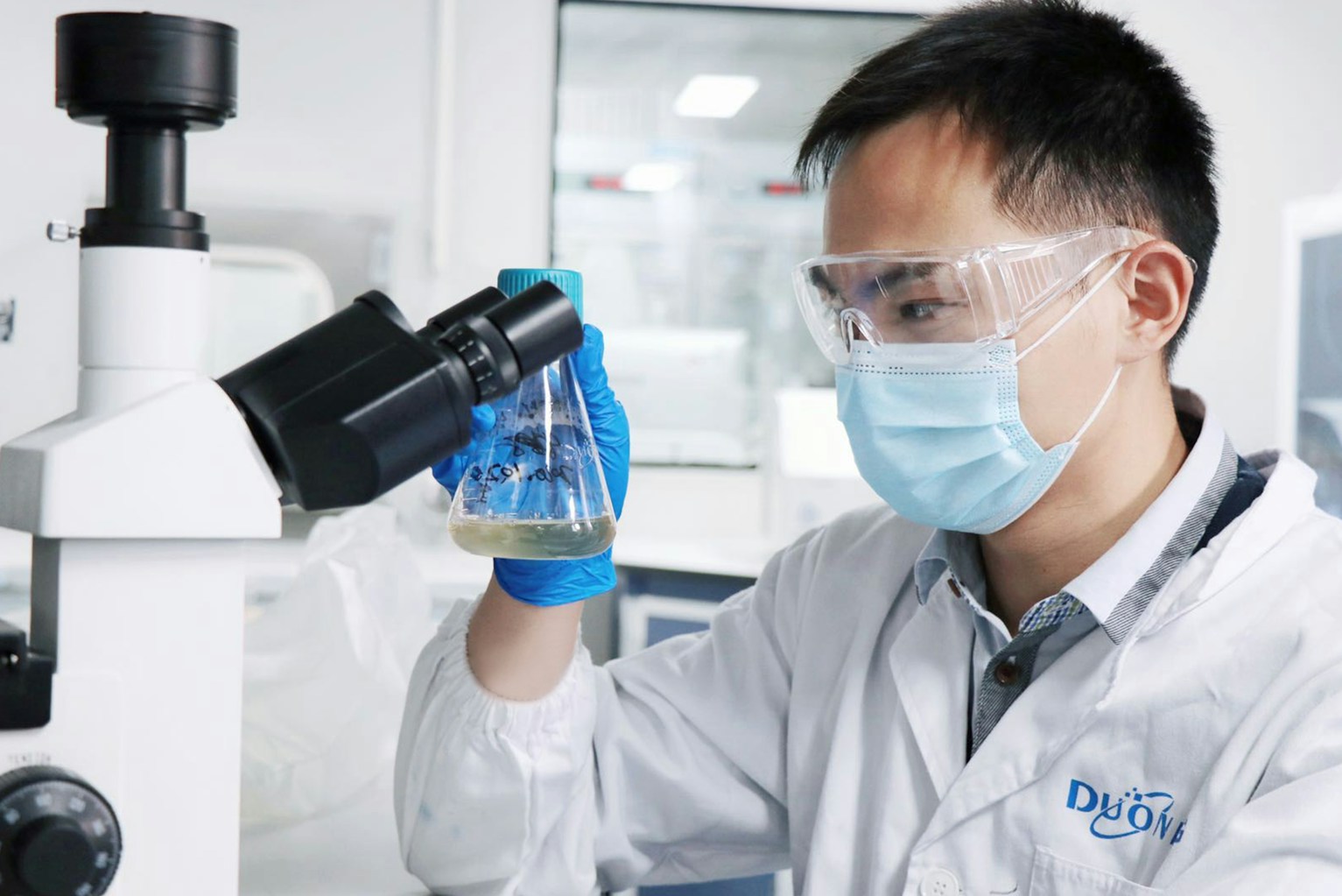 Scientist examining a sample in the lab